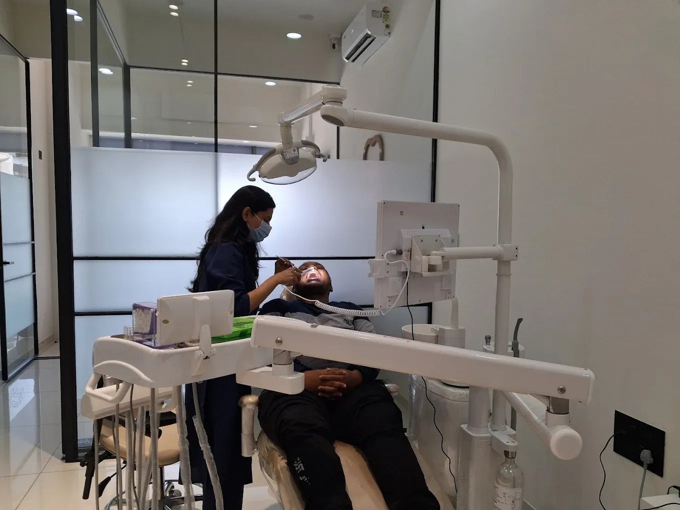 Dr. Srushti Patel treating a patient in the operatory